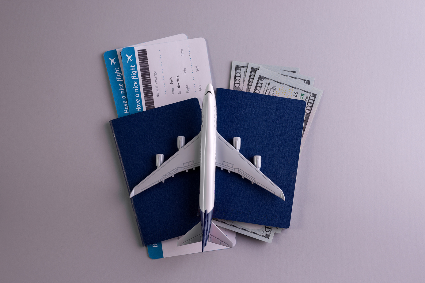 Flight Tickets with Passport and Plane Model Flatlay
